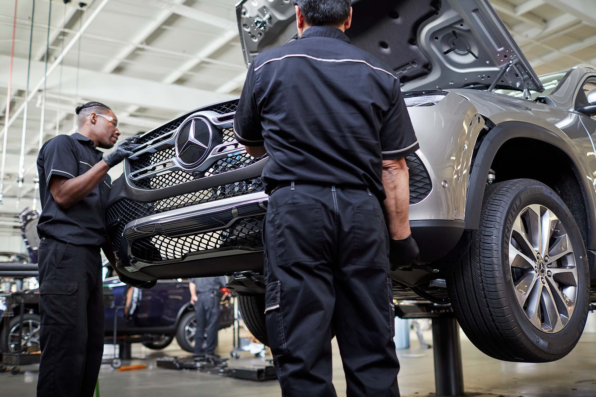 Two technicians at Knoxville Motor Company BodyWerks performing auto collision repair in Knoxville, TN