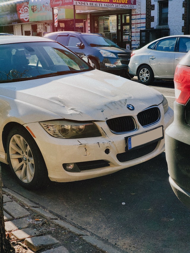 White vehicle getting dent repair in Knoxville, Tennessee at Knoxville Motor Company BodyWerks